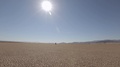 Traveler Walks Across Death Valley Landscape