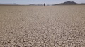 Traveler Walks Across A Hot Death Valley Landscape