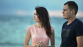 Man And Woman Looking Into The Distance Against The Background Of The Sea