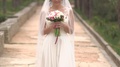 Bride With Bouquet Of Tulips And Freesias Walking On The Park Territory