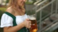 A Close-Up Of A Large Cold Glass With A Bavarian Beer In The Hands Of A Girl In