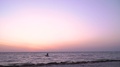 A Man Is Engaged In Kitesurfing At Dawn And Bounces Into The Air, Slow Motion