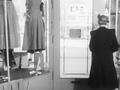 Shop Owner Opens The Door For The Old Lady As She Leaves - 1950