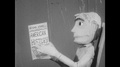 1960s: Puppet Man Sits Holding Book On American History. Puppet Man Walks To