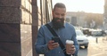 Attractive Caucasian Young Hipster Man With A Beard Chatting On The Smartphone