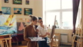 Good-Looking Girl Is Learning To Paint Having Class With Experienced Female