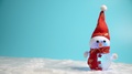 A Shining Decorative Snowman Figure Wearing A Red Christmas Hat And Red Scarf