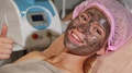 Happy Woman Showing Thumbs Up While Having Black Mask On Her Face