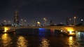 Bridge On Chao Phraya River And Skyscrapers At Night, Bangkok City