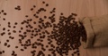 Bag Falling And Scattering Coffee Beans Top View Slow Motion