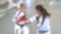 Female Black Belt Martial Artists Work On Thai Boxing Drills - Out Of Focus