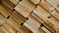 Rotation Of Background Of Shelves Of Wood. Warehouse Wooden Logs With Processing