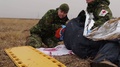 Military Medics Roll Casualty Covered In Foil Blanket Onto Stretcher