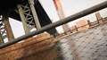 Metal Fencing On The East River In New York With Manhattan Bridge Overhead