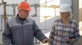 Builder And Customer Inspect The Building Under Construction Inside In Rooms