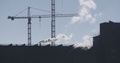 Construction Site - Cranes Over A Building With Smoke