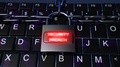 Lock With Chains On Laptop Keyboard Security Concept With Secure Breach Text