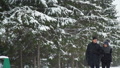 Man And Woman Walking In Snowy Weather