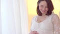 Beautiful Happy Pregnant Woman Caressing Her Belly. Pregnancy Concept. Maternity