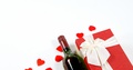 Wine Bottle, Gift Box And Scattered Red Hearts On White Surface 4k
