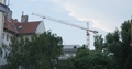 A Crane Working In The Middle Of A City