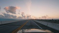 Driving A Car Along Florida Keys Overseas Highway Bridges During Sunset