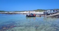 Fishermen In The Cape Launch Their Blue Wooden Boat Down A Slipway