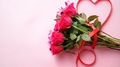 Mixed Flowers Bouquet With Roses And Heart Shaped Bow On Pink Background