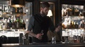 Hipster Bartender Mixologist Combining Ingredients And Making A Whiskey Cocktail