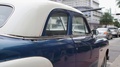 Slow Motion Pan Of Vintage 50s Car Parked In City Street