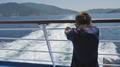 Isolated Child With Back Standing On Cruise Ship Deck Looking At The Water Trace