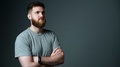 Half Length Portrait Of Young Bearded Hipster Man Looking At Blank Copy Space