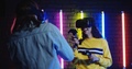 Young Cheerful Male And Female Gamers In Vr Glasses Playing A Shooting Vr