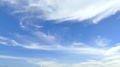 Time-Lapse Thin White Clouds In A Bright Blue Sky Pass Slowly Overhead