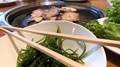 Korean Barbecue.Nclose Up Of Chop Sticks With Table Grill Cooking In