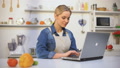 Young Pretty Woman In Apron Searching Food Recipe Instructions In Internet Blog