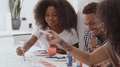 Young Adult Black Man And His Two Sisters Making Sign For A Surprise Party In
