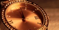 Second Hand Ticks Past Midnight On A Golden, Diamnod-Studded Women's Watch.