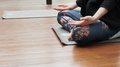 A Yoga Student In A Class During A Lesson, Practising The Lotus Position