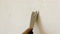 Male Hand Of Repairman With A Spatula Applies The Paste To The Wall To Seal The
