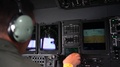 U.S. Military Flight Engineer Monitoring Control Panel Aboard C-130 Hercules