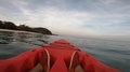 Ocean Kayaking In Early Morning With Glimpse Of Woman Legs, Beach And Mountain
