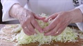 Chef In Kitchen Handling Shredded Cabbage.