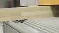 Close-Up Of Wooden Board In Wood Processing Machine. Action. Woodworking Combine