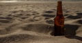 Beer Bottle On Sand At Beach 4k