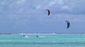 Two People Doing Kite Surfing In Open Waters In French Polynesia.
