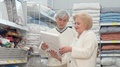 Lovely Senior Couple Shopping For Bed Sheets At Furniture Store