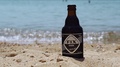 Fix Dark Greek Lager Beer On Sand By The Sea.