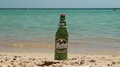 Mythos Greek Lager Beer On Sand By The Sea.
