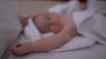 A Small Boy Sleeps On The Big Bed With White Linens, Slow Motion